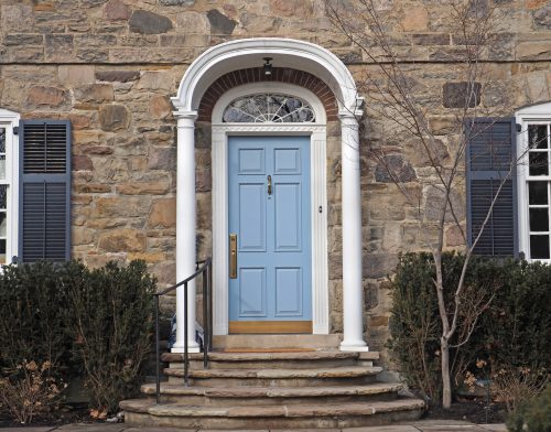 stone faced house with portico around front door
