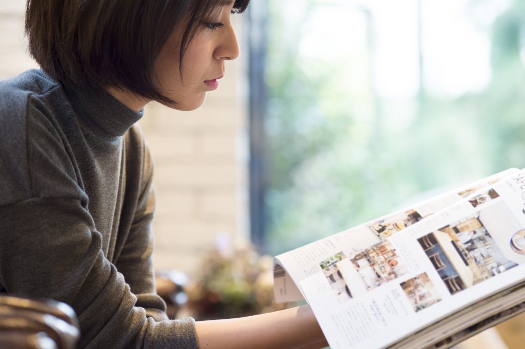 woman reading an interior design magazine
